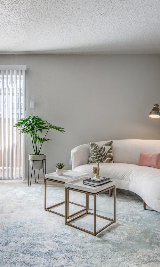 a living room with a couch, coffee table and a painting at The 8500 Harwood