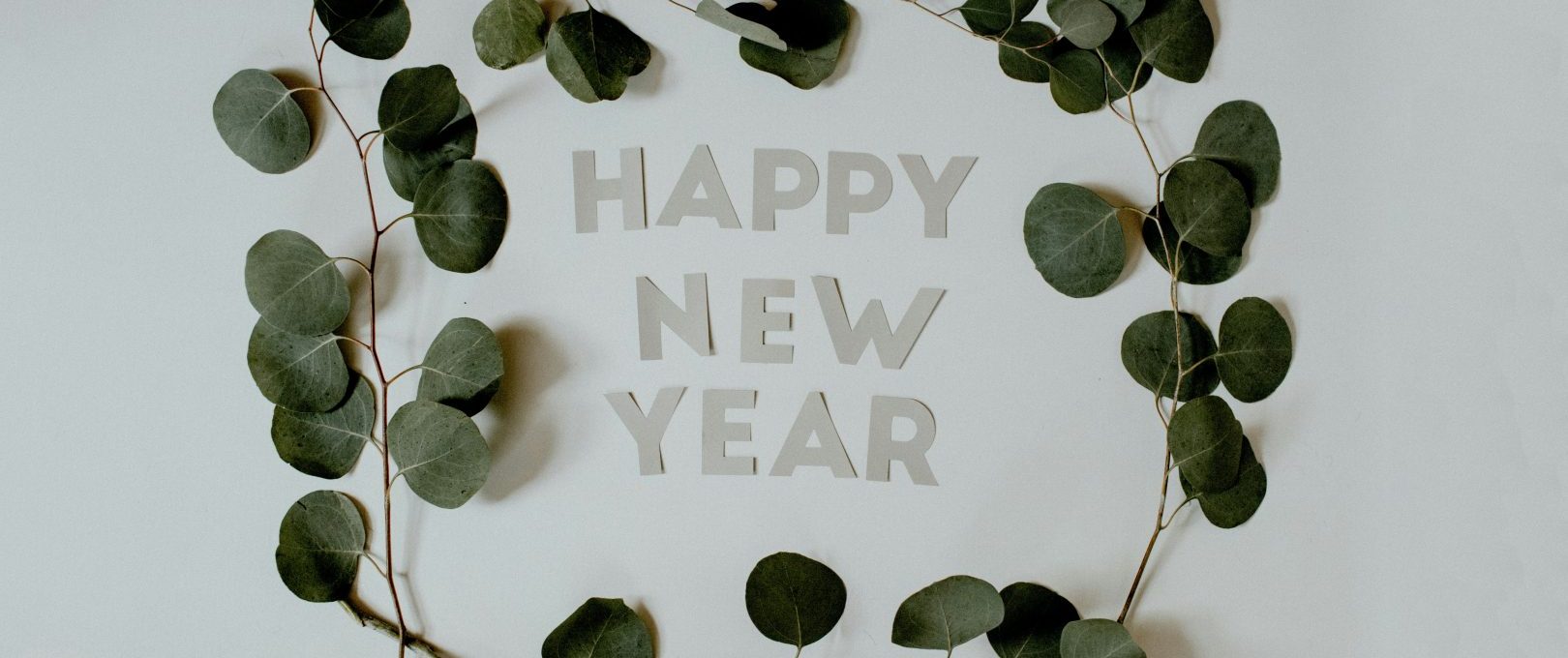 happy new year greeting card with eucalyptus leaves at The 8500 Harwood