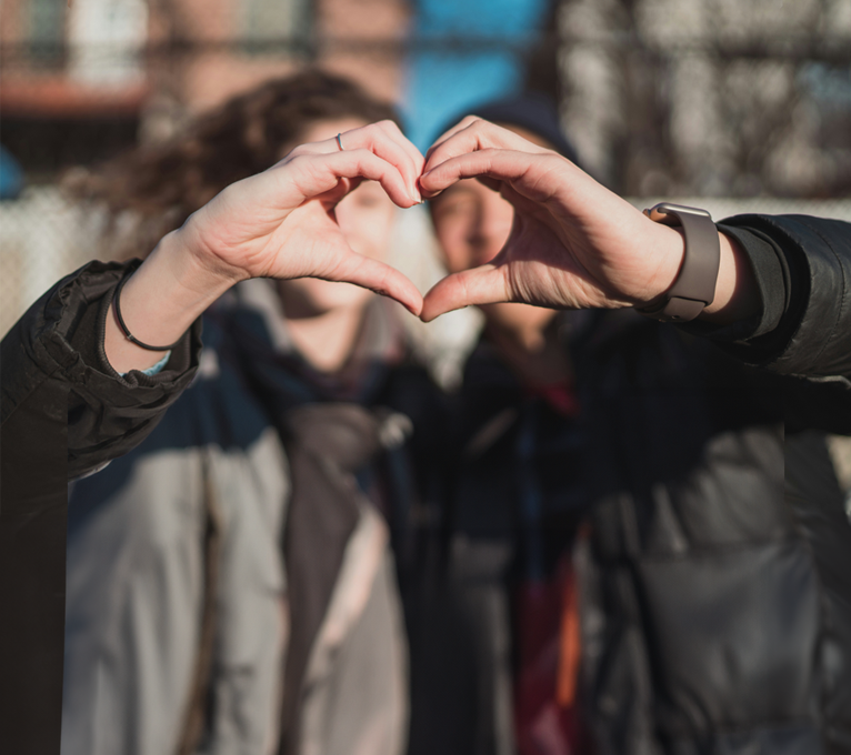 two people making a heart shape with their hands at The 8500 Harwood